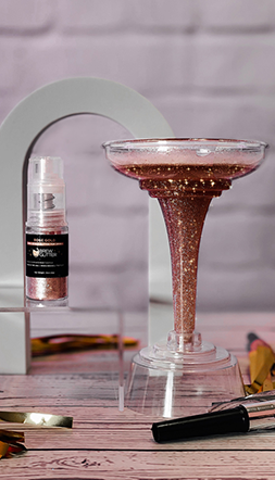 light pink drink glitter spray next to margarita glass promo shot