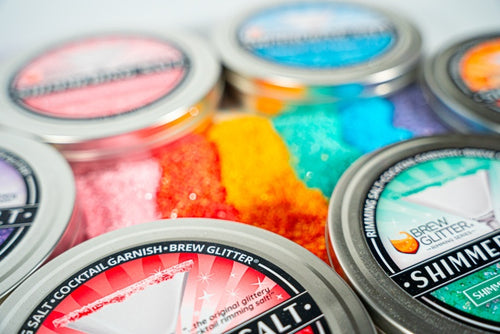rainbow shimmering salts and sugars surrounded by bar tins