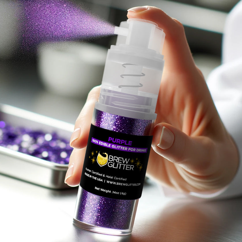purple edible glitter spray held by a hand promo shot